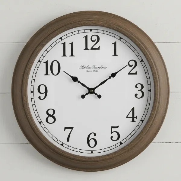 Close-up of Adalene 14-inch farmhouse wall clock with brown frame, white face, black numerals.