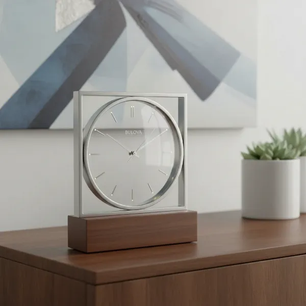 A sleek, modern Bulova table clock combining polished metal, wood, and glass, showcasing elegant design.