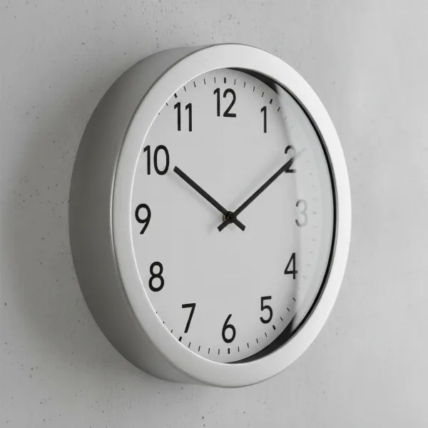 Stylish Ikea PUGG wall clock with stainless steel frame, clear glass, and minimalist white dial.