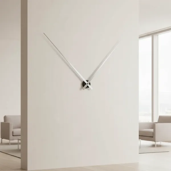 Minimalist Karlsson Little Big Time wall clock with slender hands and central hub on a blank wall.