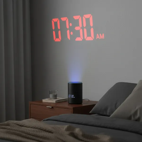 A sleek modern projection clock projecting time on a ceiling in a dark room.