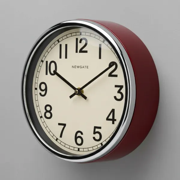 Close-up of Newgate Cookhouse Wall Clock showing chrome bezel, black hands, clear dial